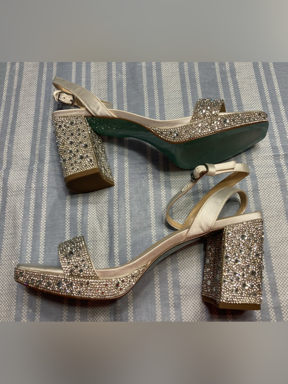 Betsey Johnson “Darbi” silver satin heels with rhinestone details.